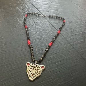 Hand crafted black and red beaded necklace with gold/red leopard face pendant.